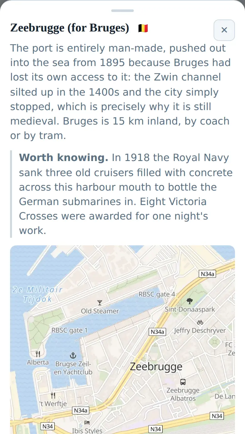The Zeebrugge page on a phone: a paragraph explaining that the port is entirely man-made, pushed out into the sea from 1895 because Bruges had lost its own access to the coast, a note about the Royal Navy sinking three cruisers across the harbour mouth in 1918, and the street map below it.