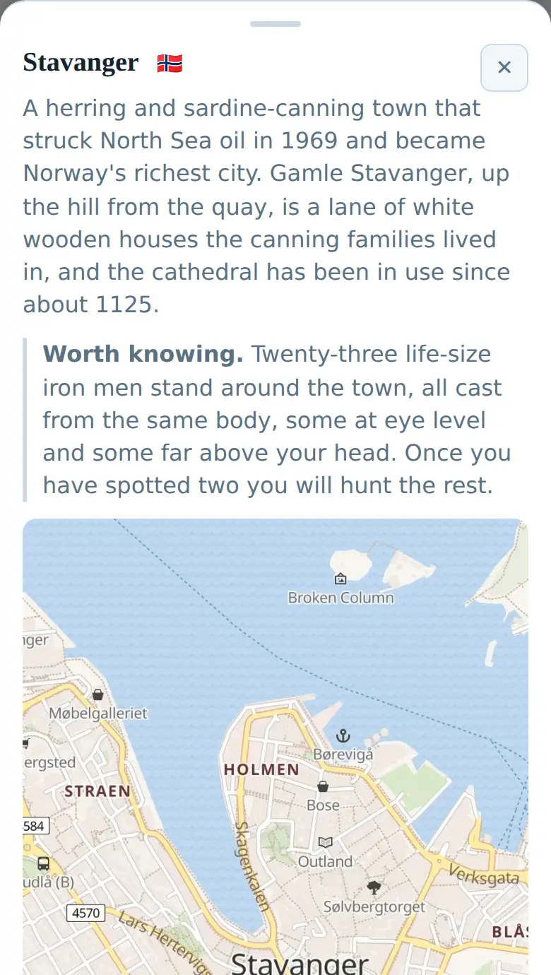 The Stavanger page on a phone: a paragraph about the herring town that struck North Sea oil in 1969, a note about the twenty-three life-size iron men standing around the town, and the street map of the harbour below it.
